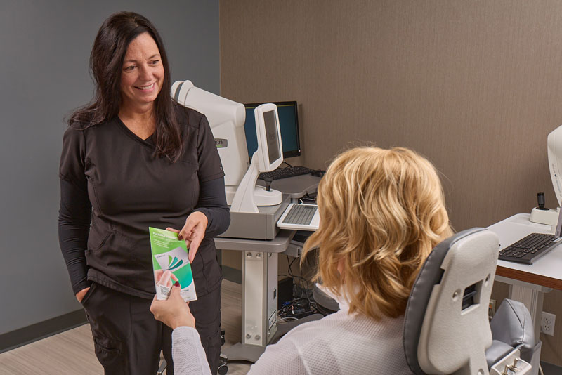 Financing brochure being handed to a Lasik laser eye surgery candidate